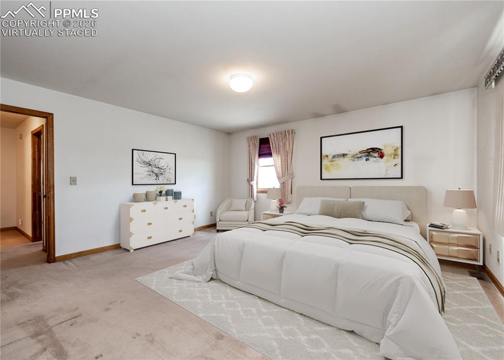 6185 Sayres Road Colorado Springs, CO 80927 - Photo 23 of 50 a room with a bed and a painting on the wall