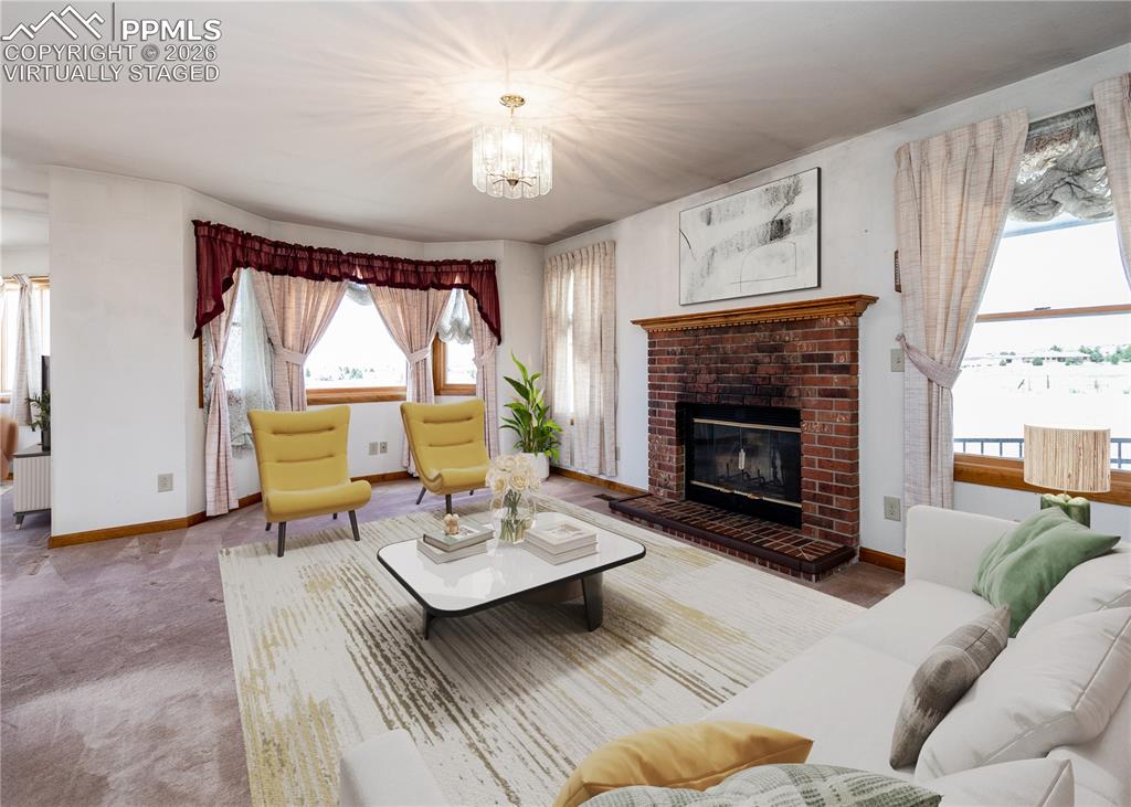 6185 Sayres Road Colorado Springs, CO 80927 - Photo 25 of 50 a living room with furniture a fireplace and a large window