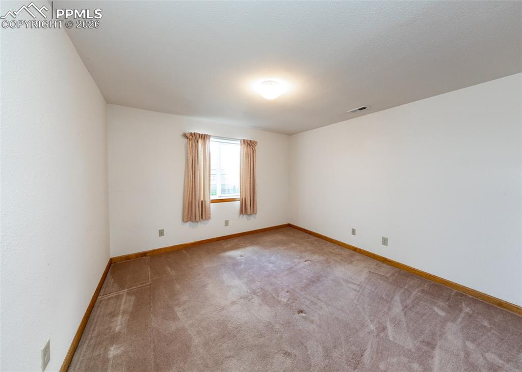 6185 Sayres Road Colorado Springs, CO 80927 - Photo 31 of 50 an empty room with a window