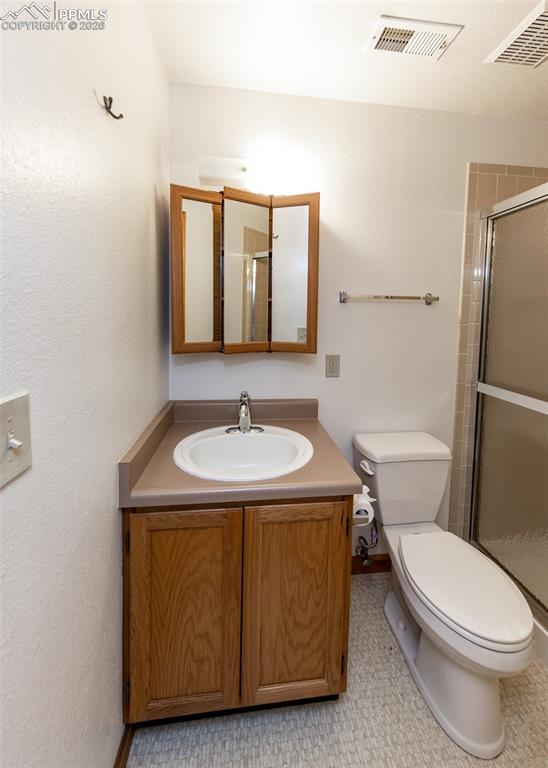 6185 Sayres Road Colorado Springs, CO 80927 - Photo 34 of 50 a bathroom with a sink a toilet and mirror