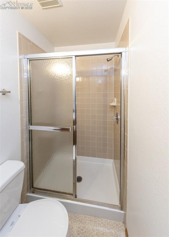 6185 Sayres Road Colorado Springs, CO 80927 - Photo 35 of 50 a bathroom with a glass shower door