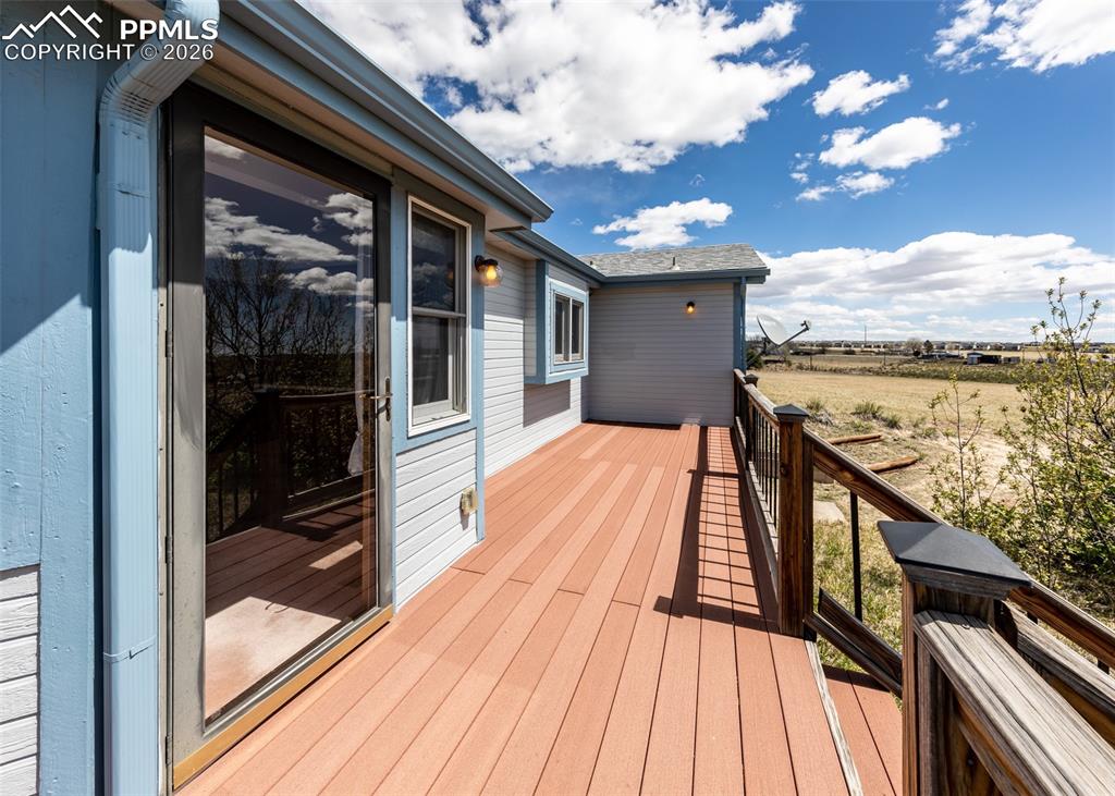 6185 Sayres Road Colorado Springs, CO 80927 - Photo 38 of 50 a view of balcony with furniture and wooden floor