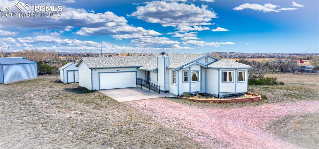 6185 Sayres Road Colorado Springs, CO 80927 - Photo 45 of 50 a view of a house with a yard