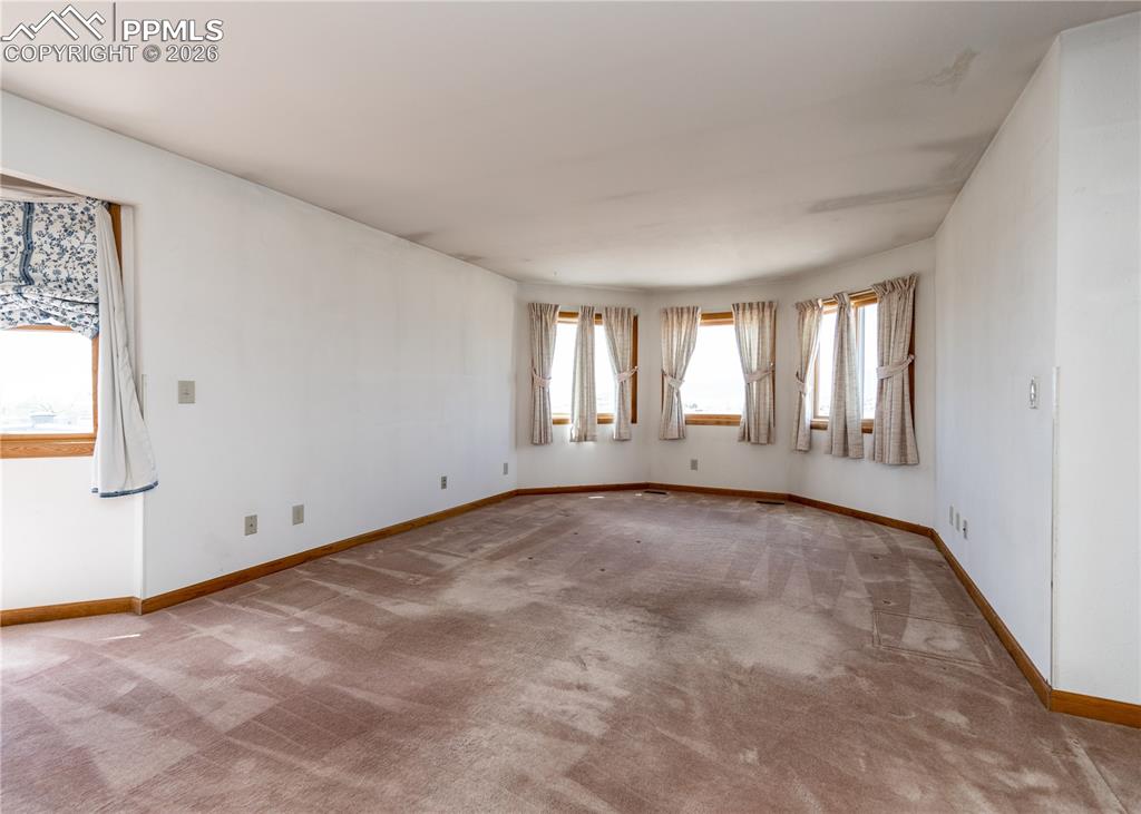 6185 Sayres Road Colorado Springs, CO 80927 - Photo 5 of 50 a view of an empty room with a window