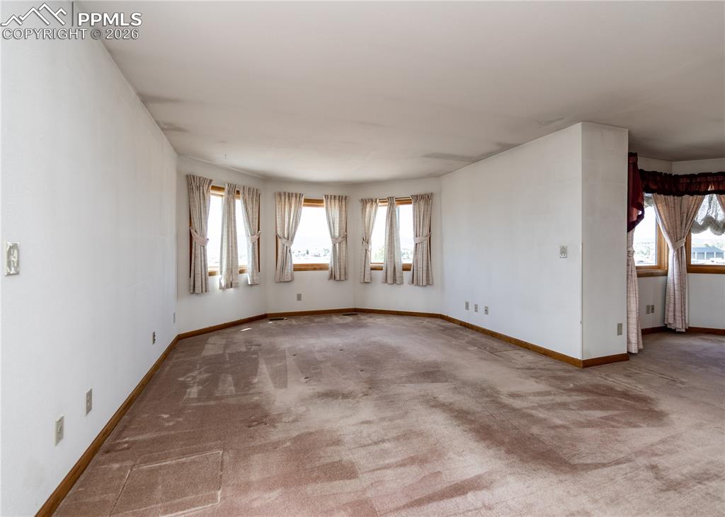 6185 Sayres Road Colorado Springs, CO 80927 - Photo 7 of 50 an empty room with windows