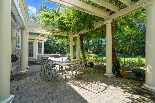 a view of a house with swimming pool and sitting area