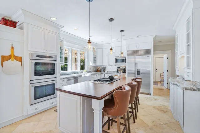 a kitchen with kitchen island granite countertop a sink and counter space