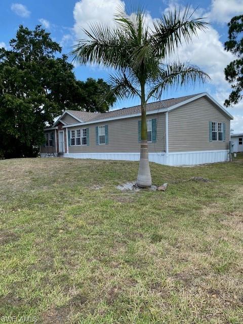 158 Rookery Road Naples, FL 34114 - Photo 2 of 26 a front view of house with yard and trees