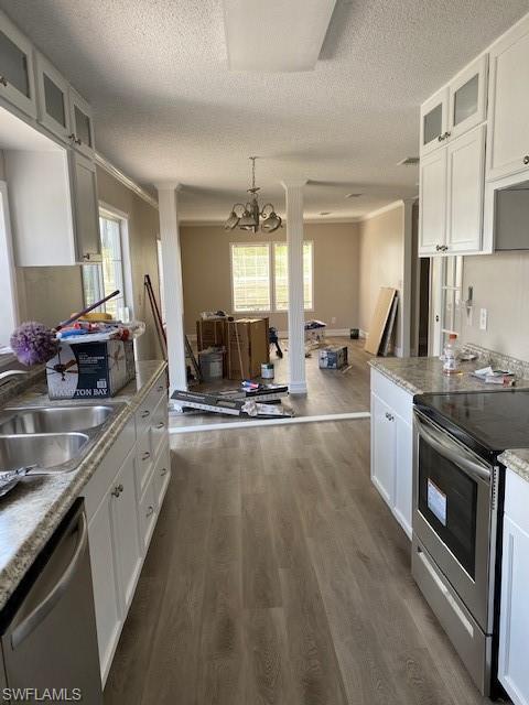 158 Rookery Road Naples, FL 34114 - Photo 4 of 26 a large kitchen with stainless steel appliances a stove a sink dishwasher and cabinets with wooden floor