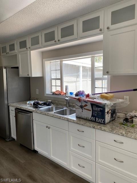 158 Rookery Road Naples, FL 34114 - Photo 6 of 26 a kitchen with stainless steel appliances granite countertop a sink and a stove