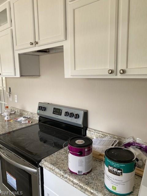 158 Rookery Road Naples, FL 34114 - Photo 7 of 26 a kitchen with a stove and a microwave