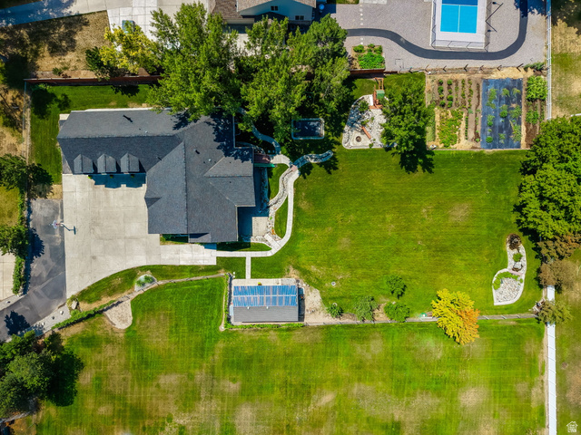 13658 South Fort Street Draper, UT 84020 - Photo 82 of 87 Expansive property featuring a large residence with a dark shingle roof, extensive concrete paving, a swimming pool, and dedicated garden plots