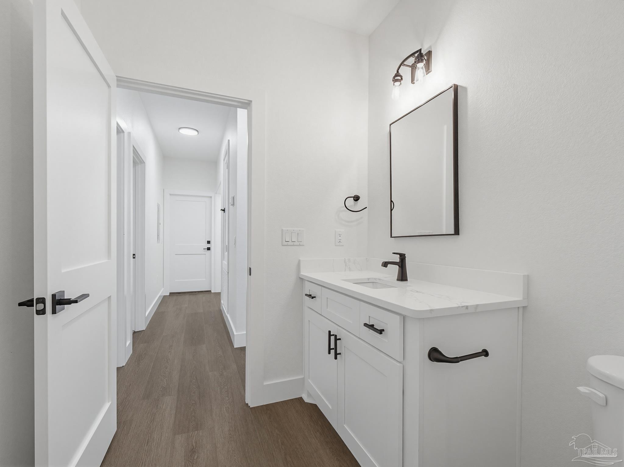 5724 Riviera Drive Milton, FL 32583 - Photo 45 of 52 a bathroom with a sink and mirror with toilet