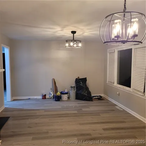 a room with lots of wooden furniture and mirrors
