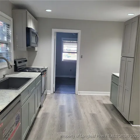a kitchen with a sink stove and refrigerator