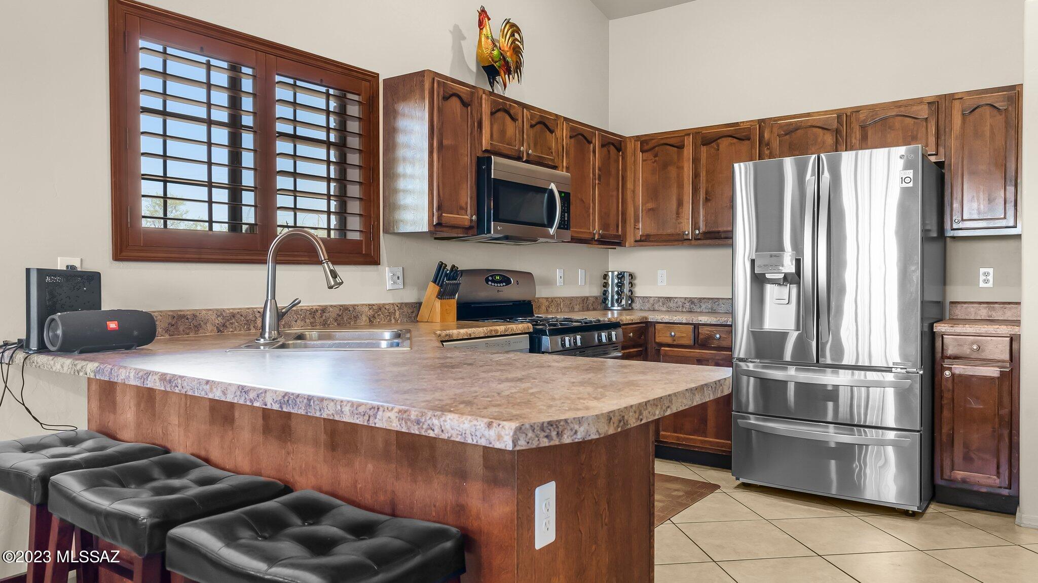 96 Calle Quintana Rio Rico, AZ 85648 - Photo 13 of 30 a kitchen with stainless steel appliances granite countertop a sink stove and refrigerator