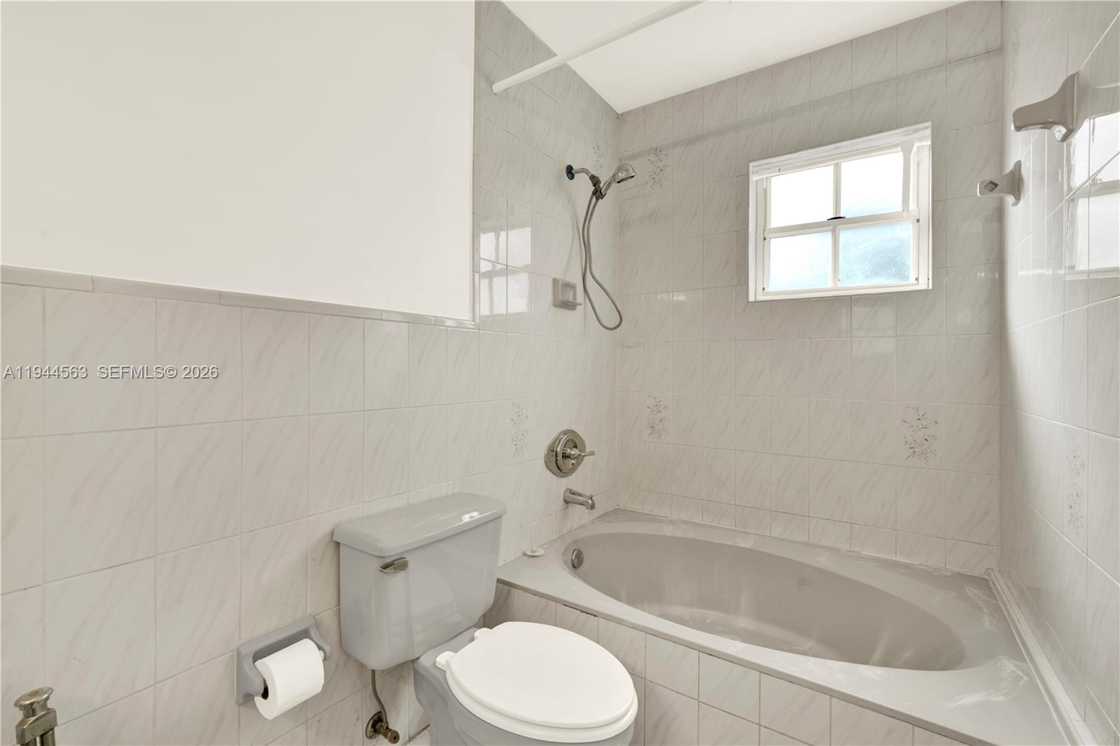 14643 Southwest 51st Street Miami, FL 33175 - Photo 21 of 23 a white toilet sitting next to a bath tub and shower