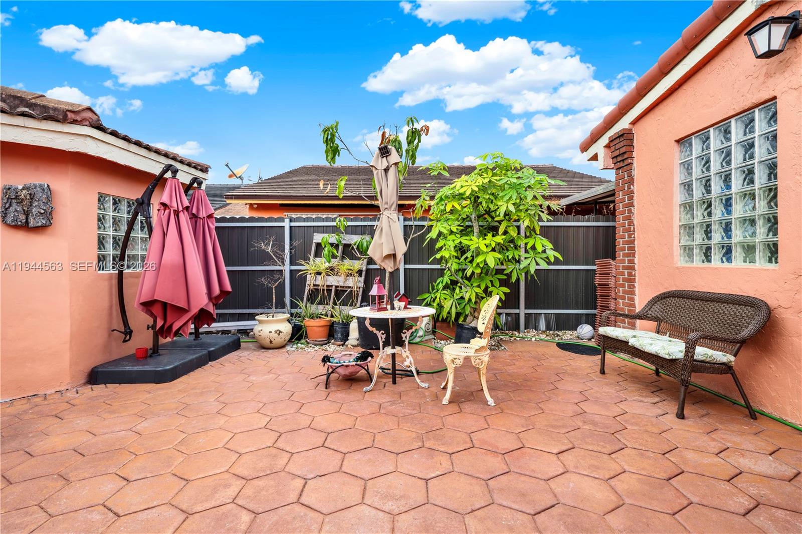 14643 Southwest 51st Street Miami, FL 33175 - Photo 4 of 23 a view of a patio with table and chairs and potted plants