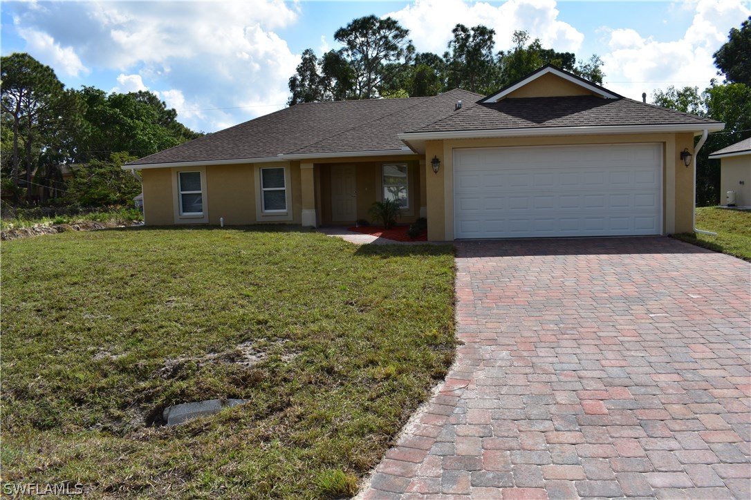 8152 Anhinga Road Fort Myers, FL 33967 - Photo 1 of 19 a front view of a house with a garden