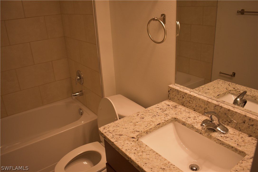 8152 Anhinga Road Fort Myers, FL 33967 - Photo 16 of 19 a bathroom with a granite countertop sink toilet and bathtub