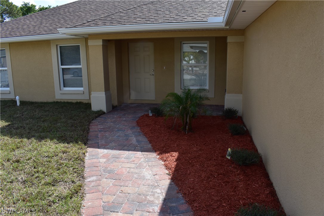 8152 Anhinga Road Fort Myers, FL 33967 - Photo 2 of 19 a view of entryway with a yard
