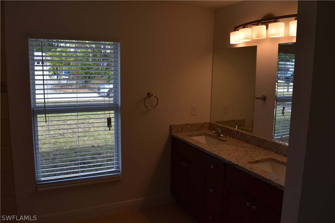 8152 Anhinga Road Fort Myers, FL 33967 - Photo 3 of 19 a bathroom with a granite countertop sink and a window