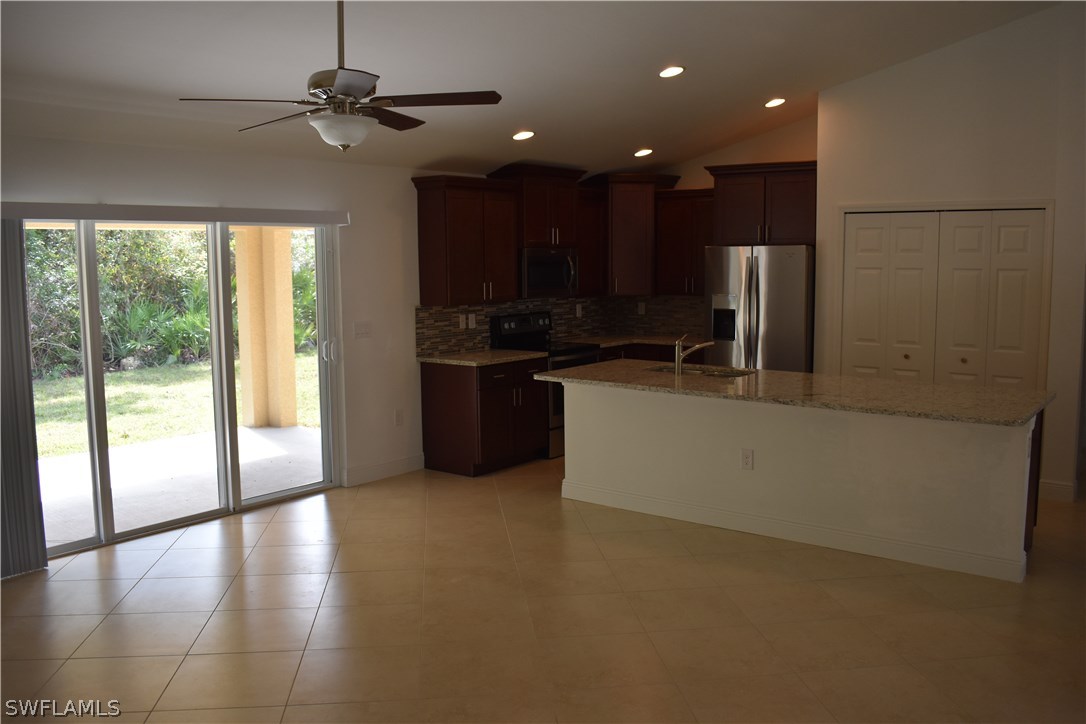 8152 Anhinga Road Fort Myers, FL 33967 - Photo 7 of 19 a view of kitchen with stainless steel appliances wooden floor and window