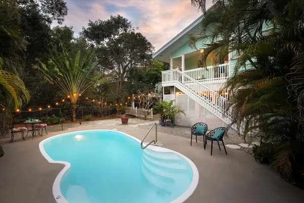 a view of a swimming pool with sitting area