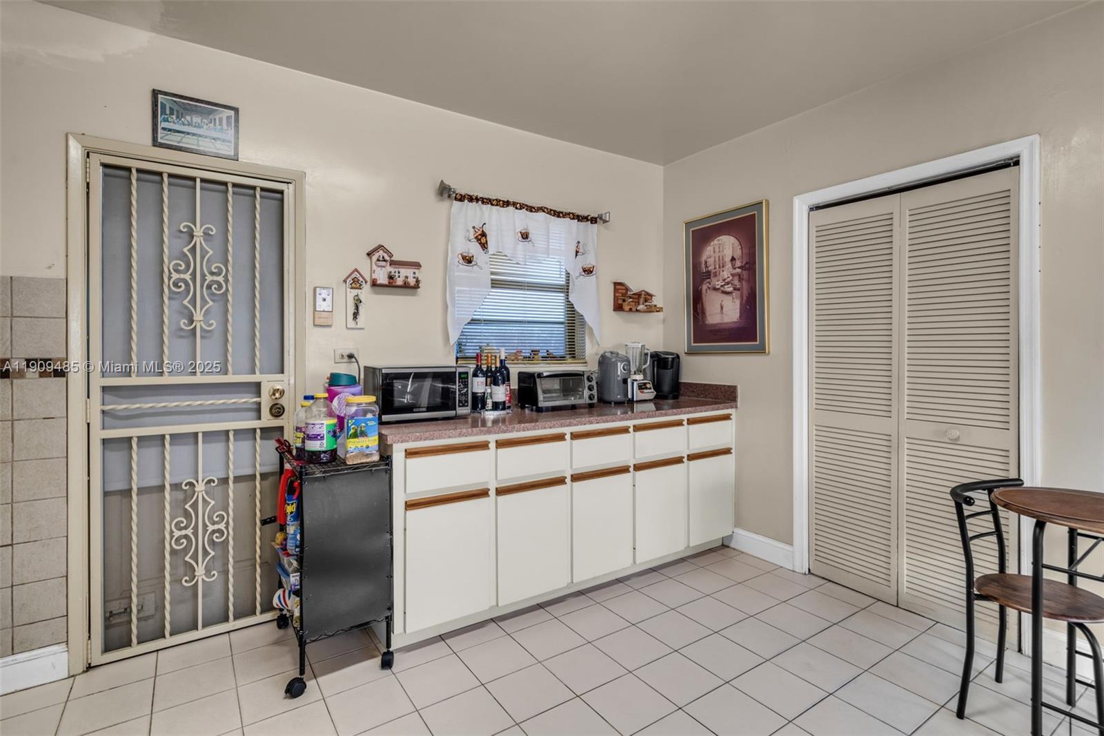 5834 Southwest 4th Street Miami, FL 33144 - Photo 12 of 33 a kitchen with stainless steel appliances granite countertop a refrigerator and a stove top oven