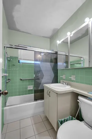 a bathroom with a sink toilet and tub