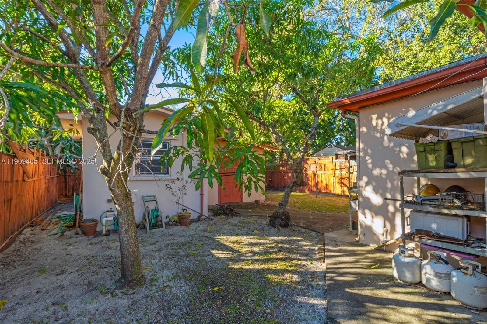 5834 Southwest 4th Street Miami, FL 33144 - Photo 20 of 33 a view of a yard with plants and a tree