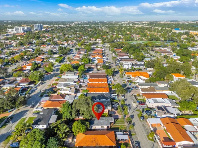 an aerial view of residential houses with outdoor space