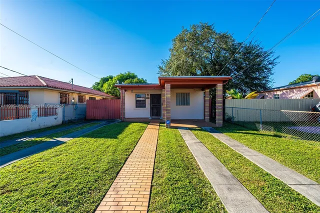 a view of house with swimming pool outdoor seating