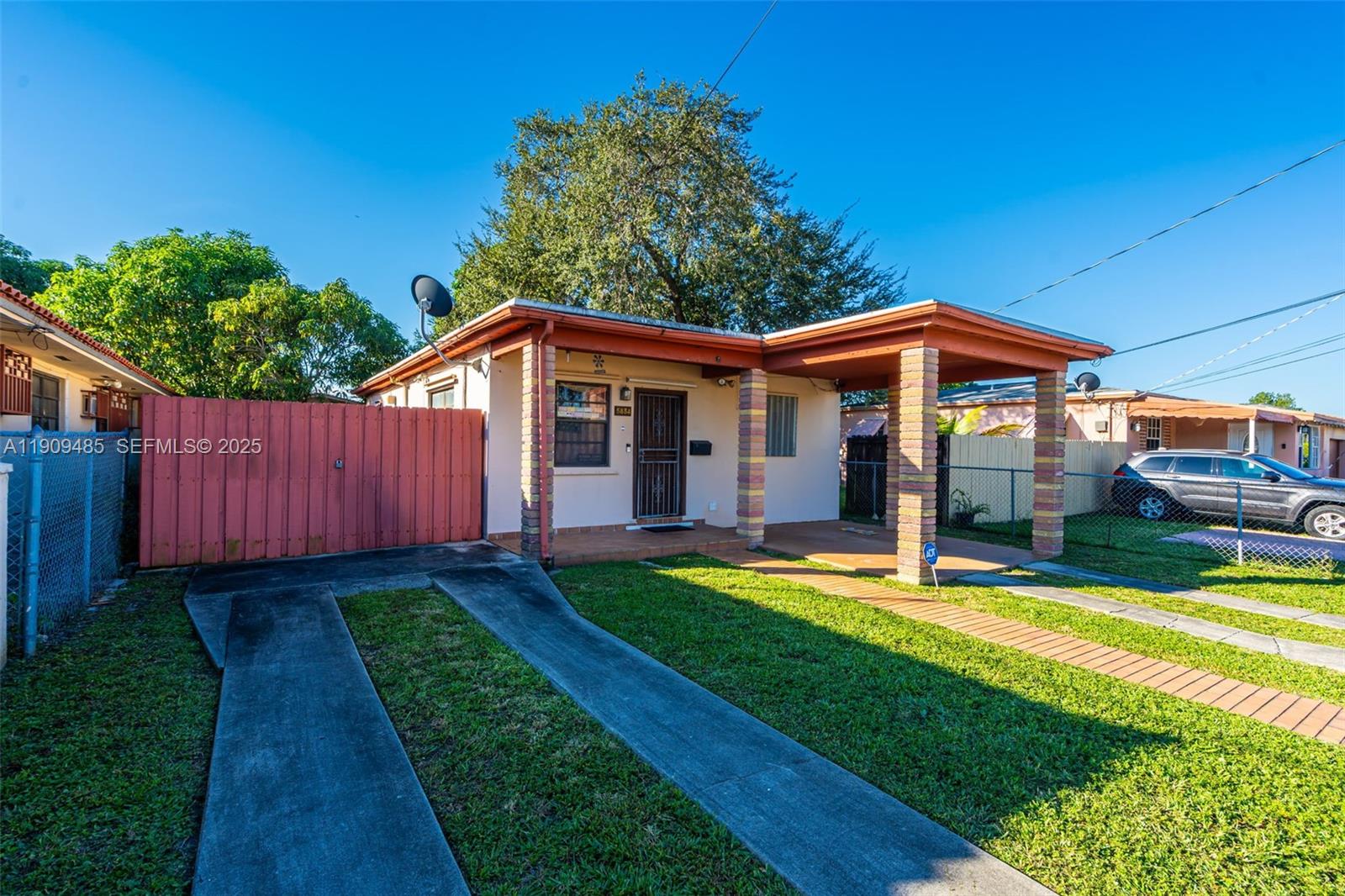 5834 Southwest 4th Street Miami, FL 33144 - Photo 5 of 33 a backyard of a house with yard table and chairs
