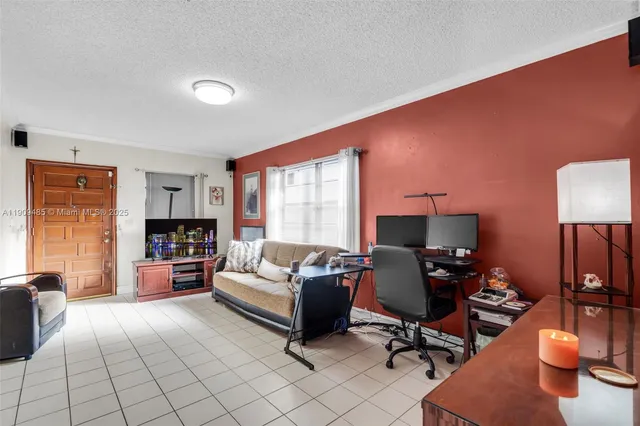 a view of a livingroom with workspace and a couch