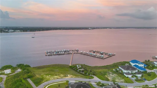 a swimming pool view with a seating space and a garden
