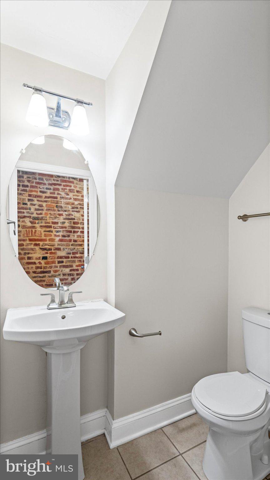 847 Carroll Street Baltimore, MD 21230 - Photo 13 of 33 Charming half-bath with brick accent.