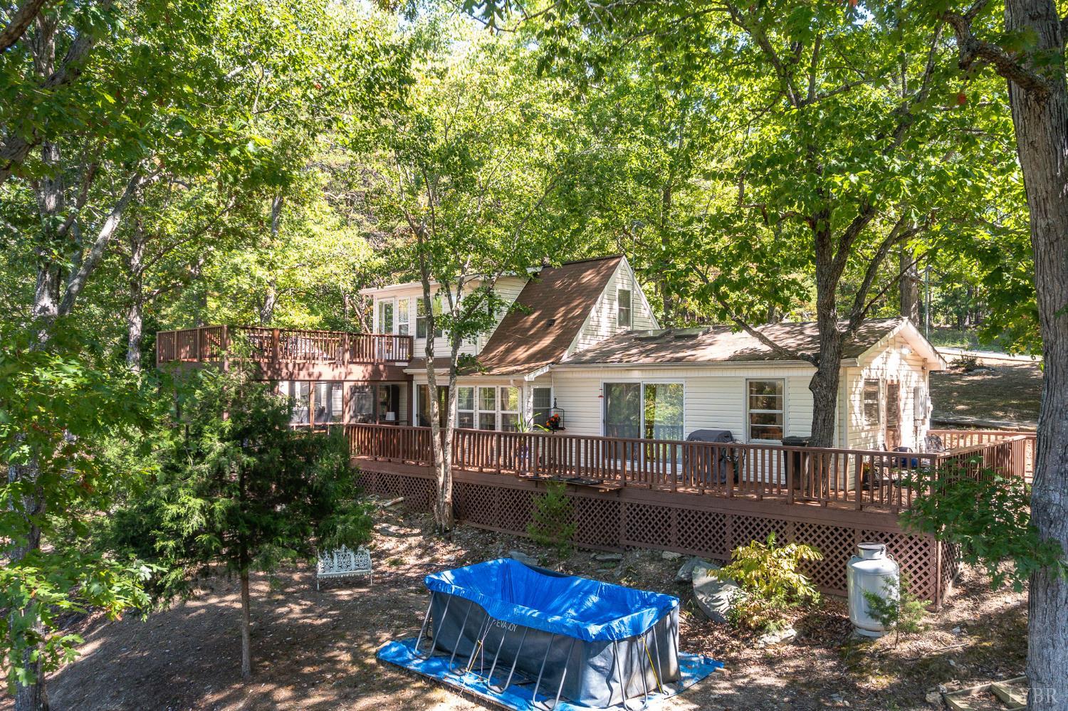 1451 Trellis Ridge Drive Lynch Station, VA 24571 - Photo 5 of 42 a front view of a house with a garden and swimming pool