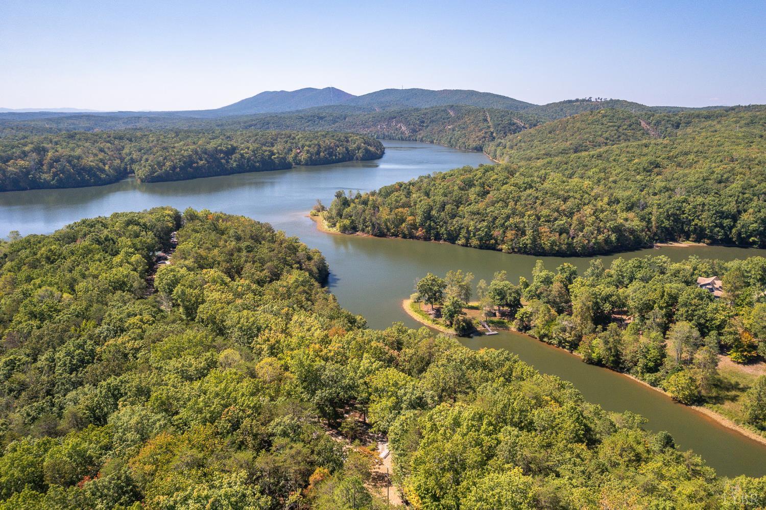 1451 Trellis Ridge Drive Lynch Station, VA 24571 - Photo 7 of 42 a view of a lake with mountains in the background