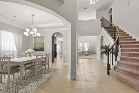 a dining room with furniture and a chandelier