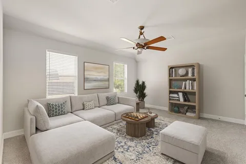 a living room with furniture a rug and a window