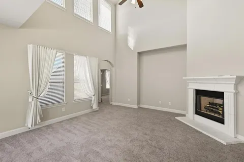 a view of empty room with a fireplace