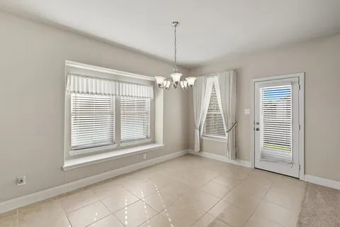 a bathroom with a granite countertop sink and a large mirror