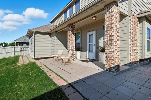 a front view of house with a garden