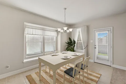 a view of a dining room with furniture and window