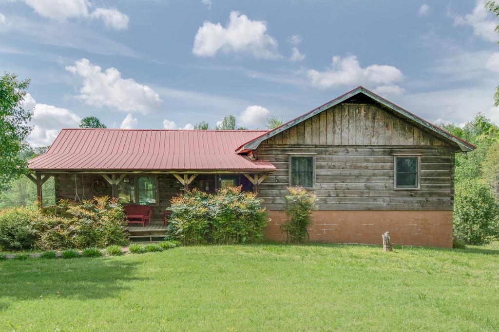 6815 Williams Road Cross Plains, TN 37049 - Photo 1 of 26 a front view of a house with a garden