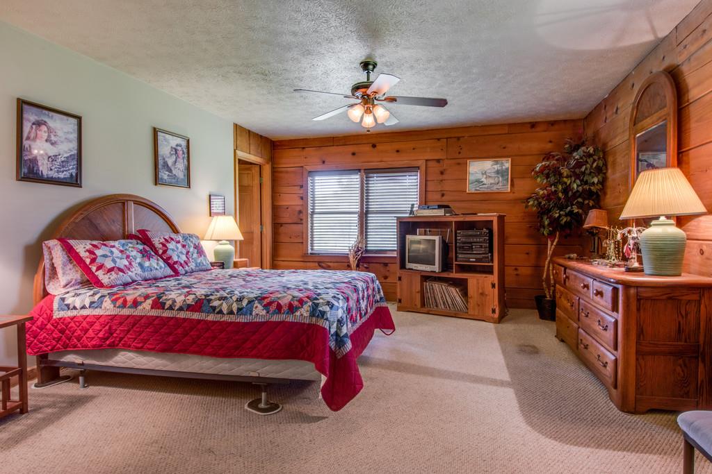 6815 Williams Road Cross Plains, TN 37049 - Photo 12 of 26 a bedroom with a bed and a chandelier
