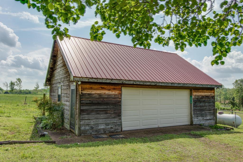 6815 Williams Road Cross Plains, TN 37049 - Photo 25 of 26 a front view of a house with a garden