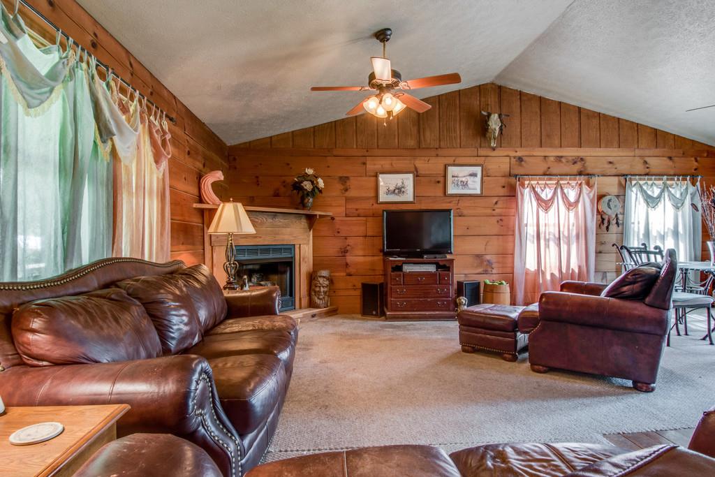 6815 Williams Road Cross Plains, TN 37049 - Photo 6 of 26 a living room with furniture a fireplace and a flat screen tv