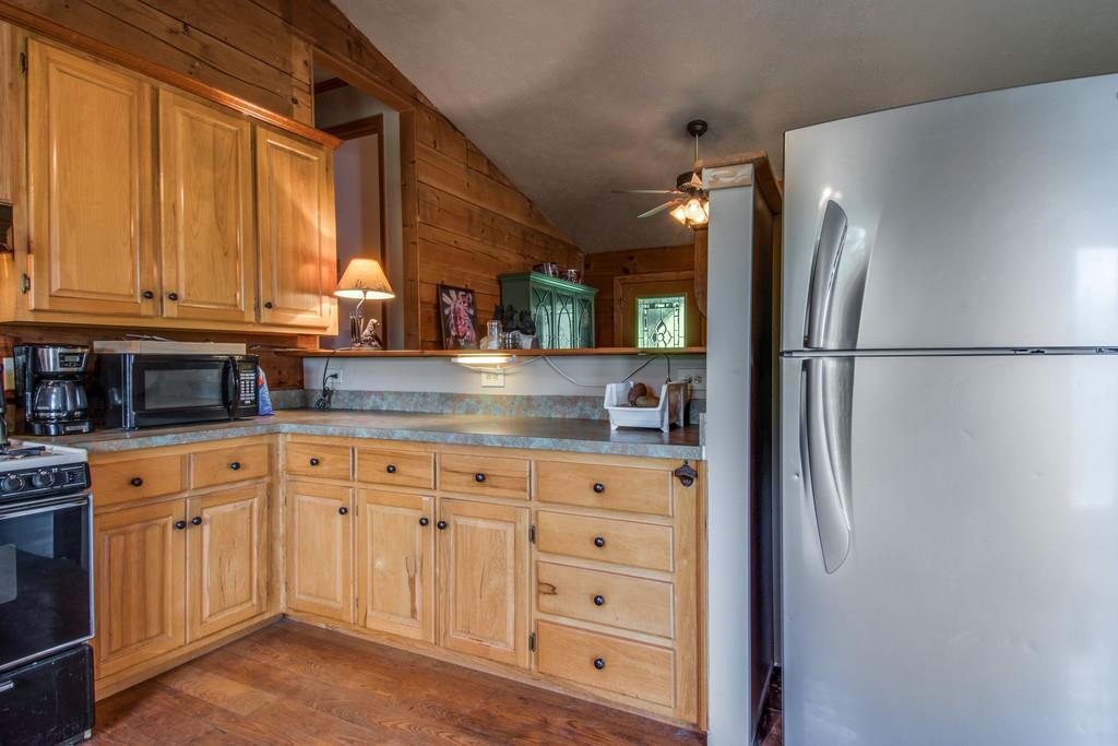 6815 Williams Road Cross Plains, TN 37049 - Photo 10 of 26 a kitchen with white cabinets and refrigerator